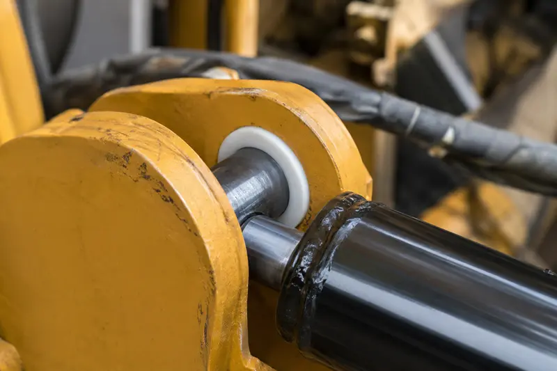 A PTFE bushing installed in an industrial hydraulic cylinder pivot point