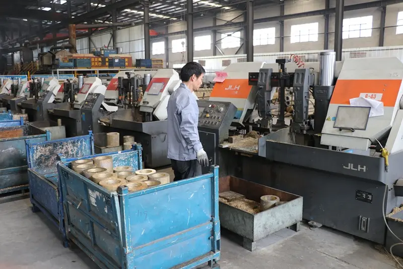 an engineer and a supplier discussing a technical drawing of a machine